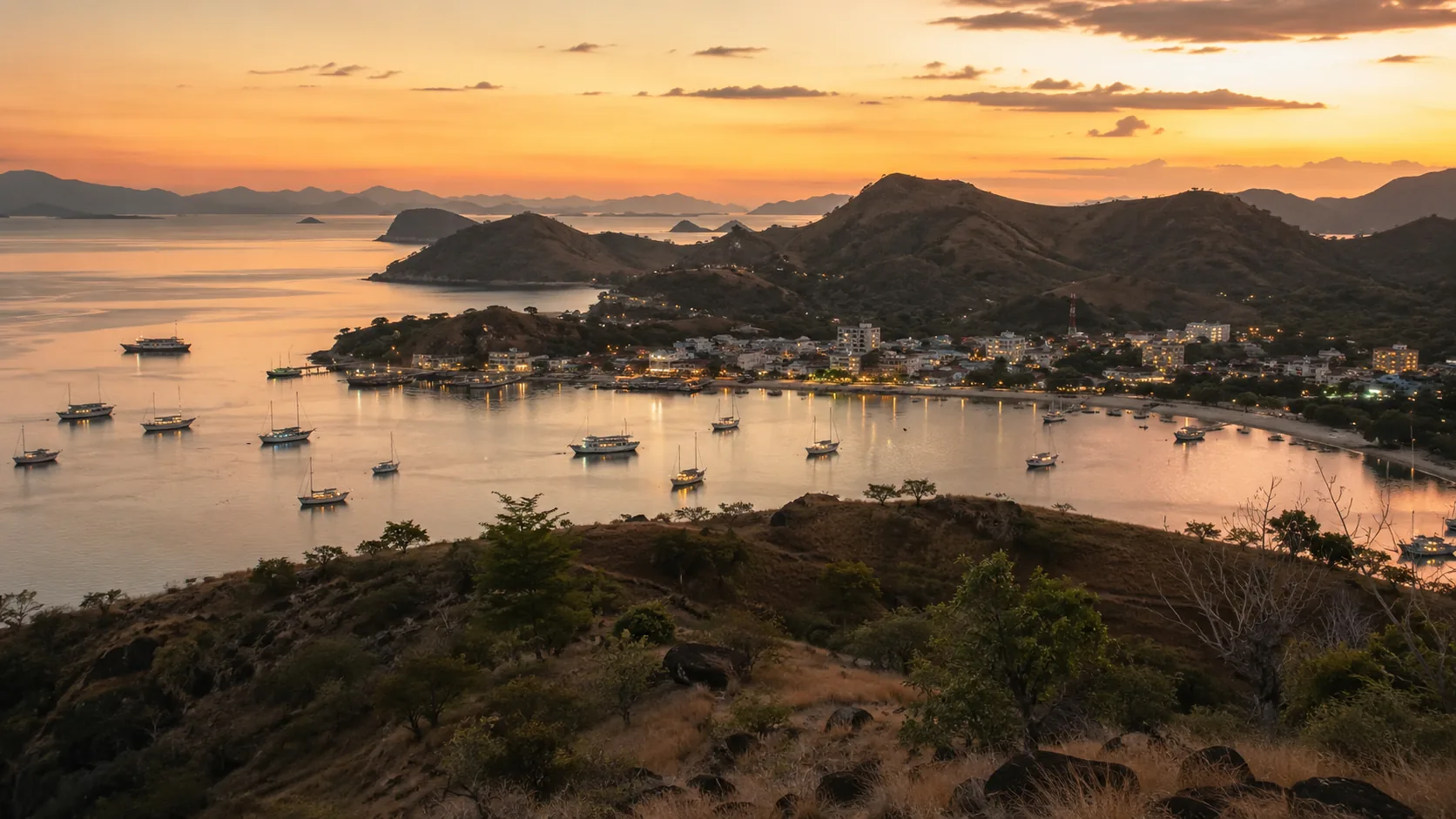 Labuan Bajo harbor at dusk with moored boats